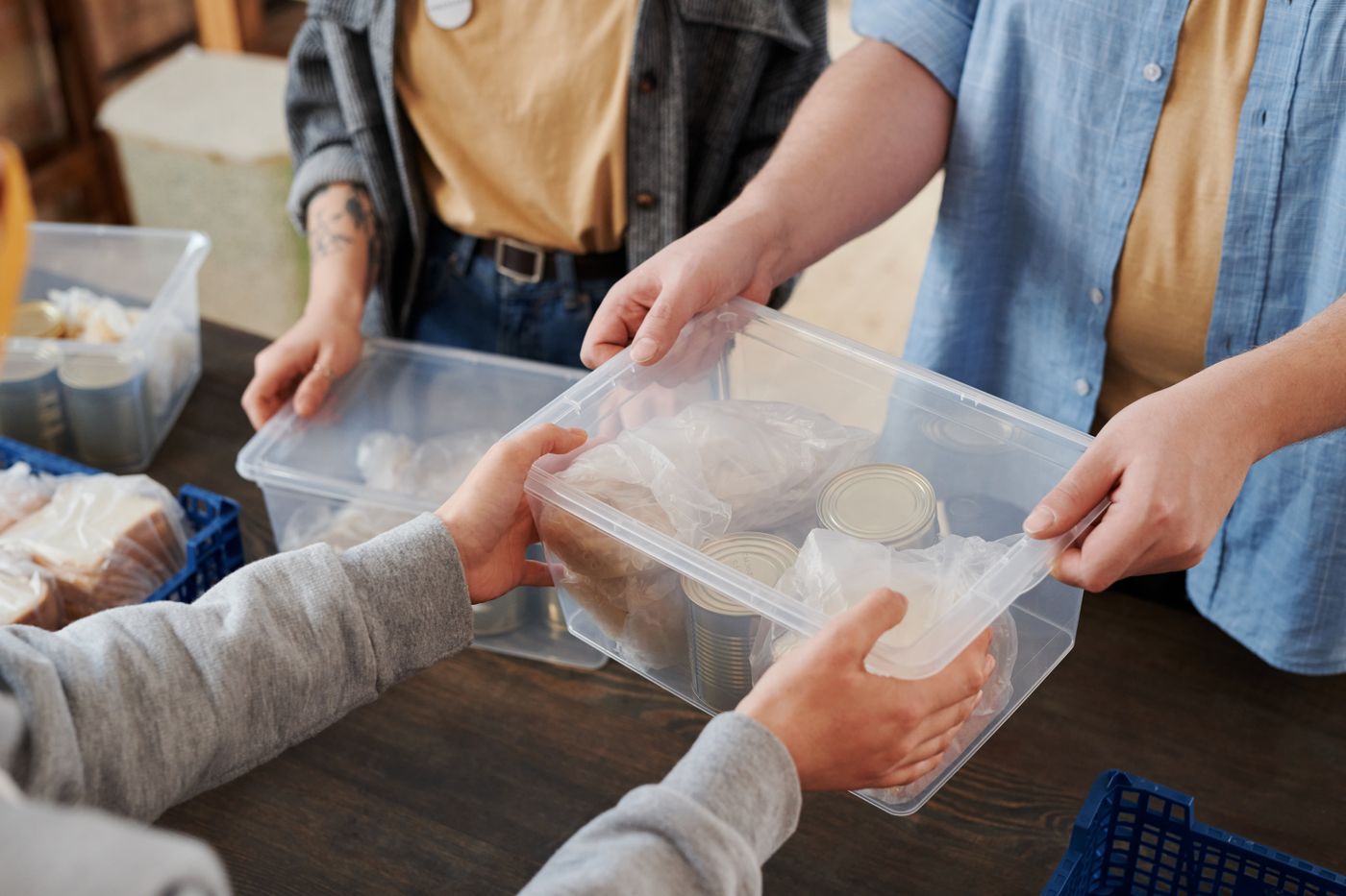 Volunteers handing over a box of food
