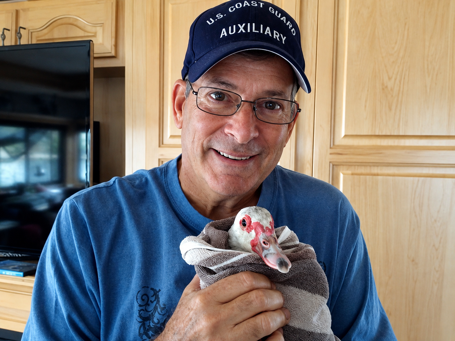Richard Glazer smiling while holding a bird